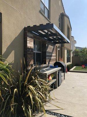 BBQ, recliamed wood back splash with a steel arbor.