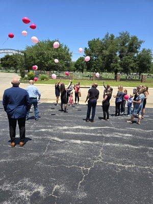 Releasing balloons up to heaven with a hand written message