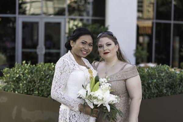 Bride in a white lace top & Maid of honour in a gold dress.