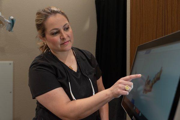 Dr. Montroy examining a 3D impression of a patients teeth