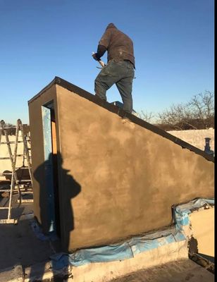 New layer of APP 160 Firestone rubber roof being installed  over the bulkhead and and new skylight