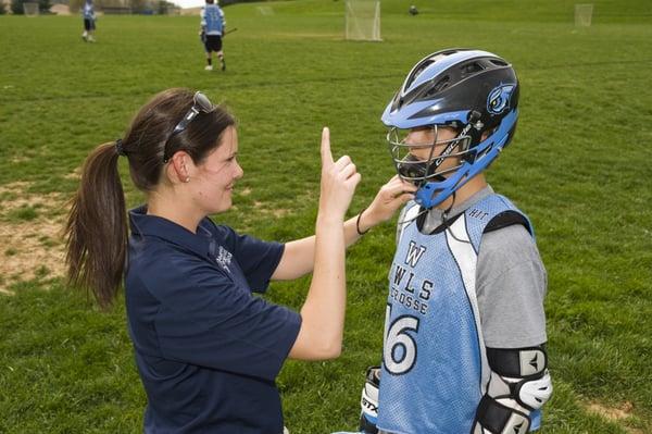 Pivot athletic trainer Katie Cicia out in the field working on concussion management with a student athlete.