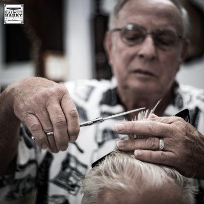 Barber ElRoy Dannhaus working one of his longtime customers at Otto's Barbershop in Brenham, TX.