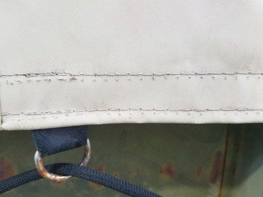 Misaligned stitch and then restitched leaving needle perforations