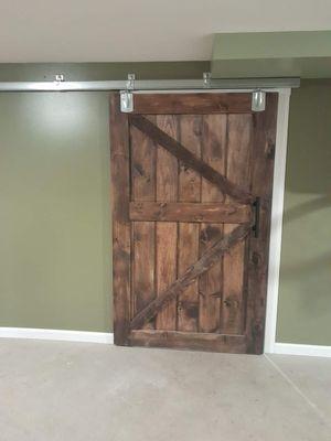 Custom barn door with remodeled walls and trim work