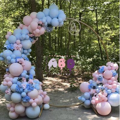 Boy or Girl gender reveal hoop paired with floral rental.