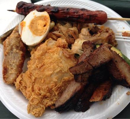 Combination of grilled hotdog, fried chicken, pakbet, chicken adobo, grilled pork, fried fish, grilled veggies, salted egg