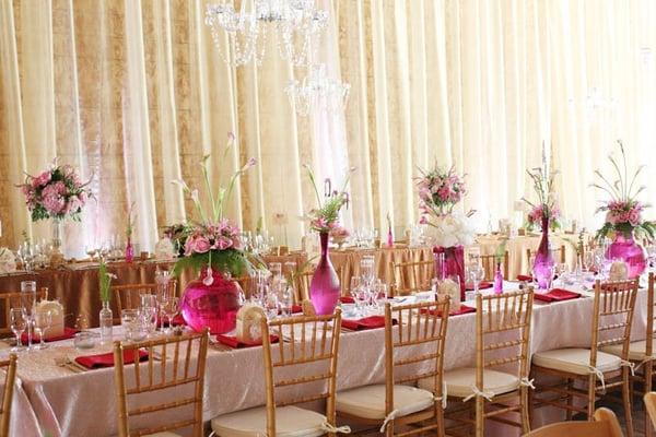 Barn wedding with draped walls and table decor.