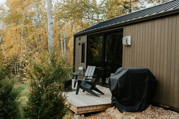 large gas grill for outdoor cooking, eastern red cedar trees, private patio deck with adirondack chairs, smokeless solo stove at Tofte Trail