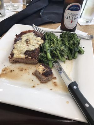 12 ounce New York strip steak with blue cheese melted on top. With a side of broccoli and a Michelob Ultra.