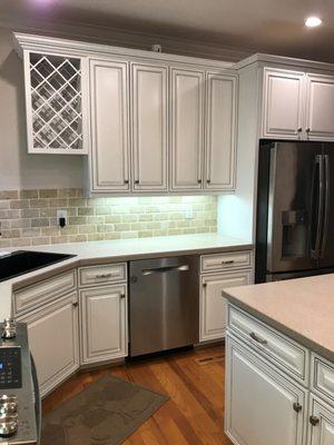 After photo. Kitchen cabinet color change from dark wood stain to white