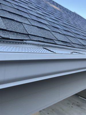 Drip Edge installed too high pushing up the shingles causing water to flow behind the gutters