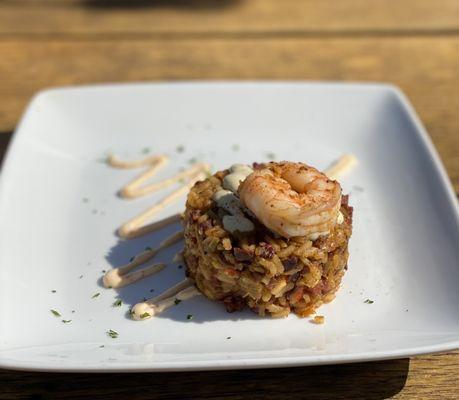 Dirty rice appetizer with one grilled shrimp