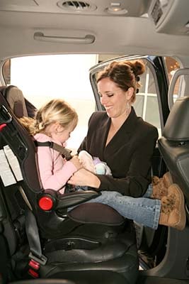 Caregivers secure children in the car seats.  Drivers are available to make sure the child is properly secured.