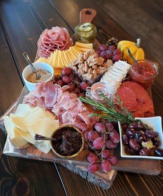 "The Boar" - Large Board; Serves 8-10; 3 cheeses, 3 meats, pickles, candied nuts, fruit/edible garnish, crackers & baguette; Choose 4 sides.