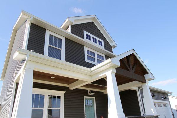 The EcoTek 1200 - 2200 Series windows with grids add a traditional touch to this home's exterior while significantly enhancin...