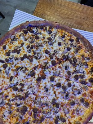 Large Hamburg and mushroom pizza