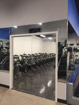 Entire gym with mirrors and entrance doors