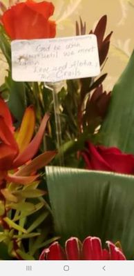 Flowers with poorly hand written note.