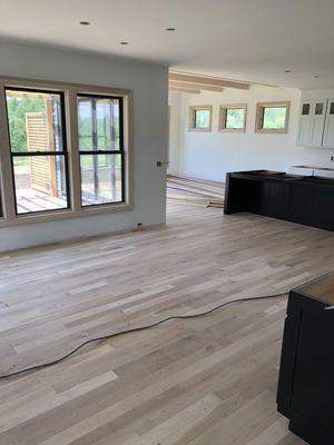 A view of the newly installed hardwood going out to the back porch. Bantam Lake area CT.