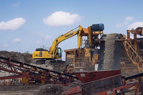 Excavator loading material into our concrete crusher