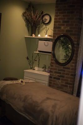 Our warm and inviting private massage room. Complete with hot towel warmer, and table warmer.