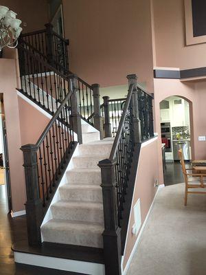 Here we replaced the newel posts with a  modern boxed newel and changed the balusters to iron.