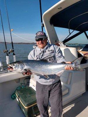 The captain catching a salmon