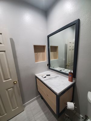 Bathroom remodel
Custom vanity
Mirror molding 
Wall niche 
Tile floor
Trim entire bathroom 
Next the sink!