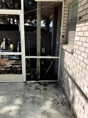 Dirt and grime loose by pool cage entrance door.