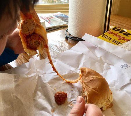 The little one contemplating cheesy goodness (meatball sub)