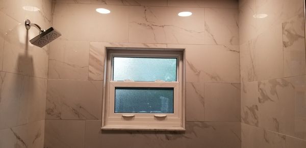 Tile to left of the window doesn't match. Cost of a piece of matching tile is @$2.00. Zero pride in work or attention to details.