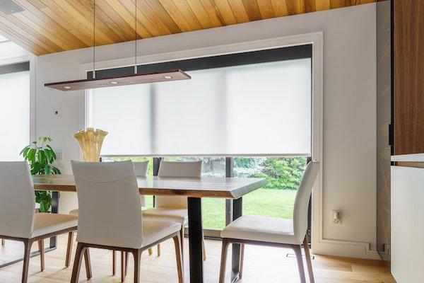 Looking for a sleek finish? Our roller shades are the perfect option! These shades complement the kitchen's furniture & walls perfectly!