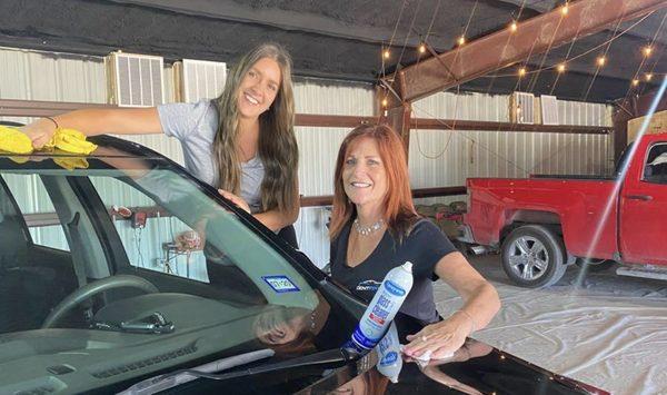 Torey and Jessica getting a car ready for our customer to pick it up.