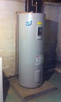 60 gallon electric water heater with new poured concrete pad