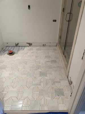 Tiling on the bathroom floor.