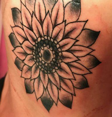 Black and grey sunflower on the ribs by Mike