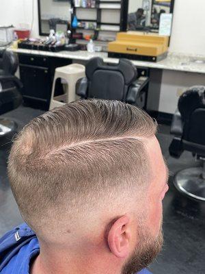 Bald mid fade with hard part