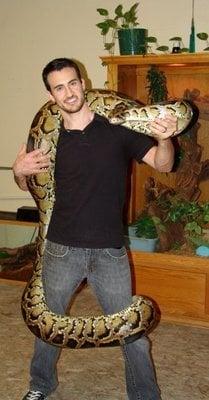 Owner, Robert Coral, holding one of the many animals on display (Burmese Python).