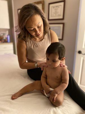 Owner/Physical Therapist/Myofascial Release Therapist/Birth Doula Krissy Chin PT, MSPT treating one of her younger clients