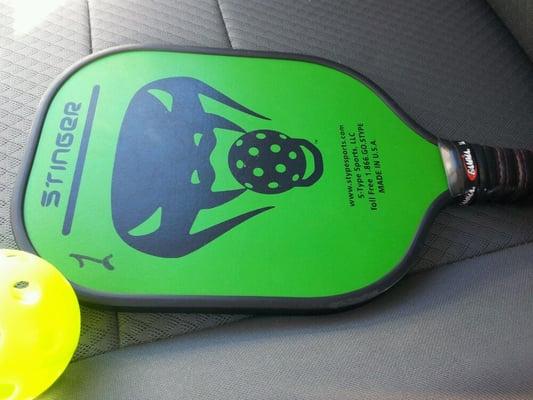 Pickleball and paddle.