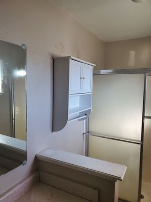 Mirror, linen closet, sliding shower doors.