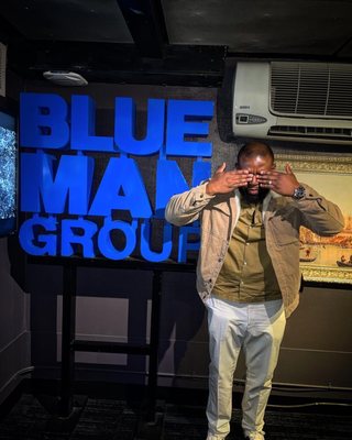 Posing with the blue man logo