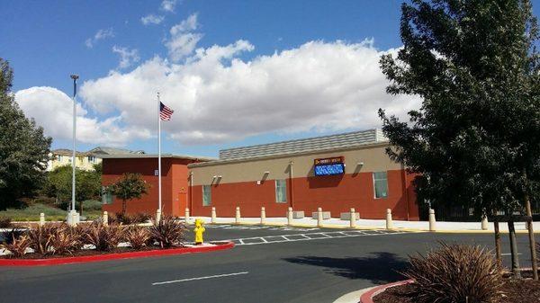 Library and flag pole. Bus / permit parking area