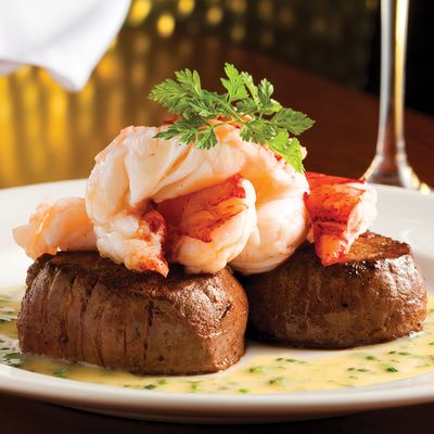 Seared Tenderloin with Butter Poached Lobster Tails – the ultimate surf and turf experience.