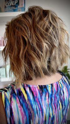 Partial highlights with textured asymmetrical bob