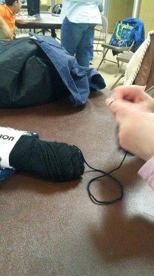 The seamstress working on another custom hat