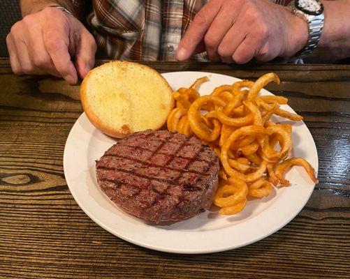 "Damn Good" hamburger and curly fries.