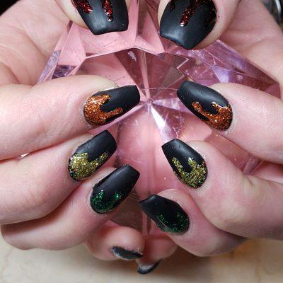 Rainbow glitter dripping on matte black nails - show your fun side!