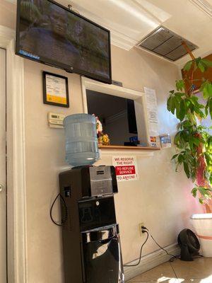 Front desk, tv, and water dispenser